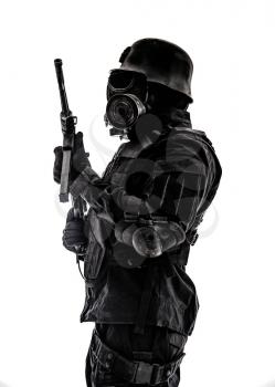 Futuristic nazi soldier sentinel gas mask and steel helmet with schmeisser handgun isolated on white studio shot standing to attention profile