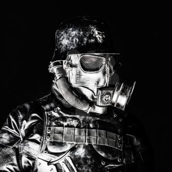 Futuristic nazi soldier gas mask and steel helmet with schmeisser handgun black background studio shot closeup portrait