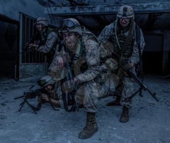U.S. marines assault squad, commando special detachment, army elite team armed with automatic weapon, yelling and attacking enemy, breaking through with fight, rush with fire during urban firefight