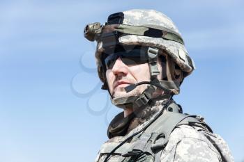 Portrait of United states airborne infantry man, camouflage uniforms dress. Combat helmet, tactical light, headphones, radio microphone on his mouth