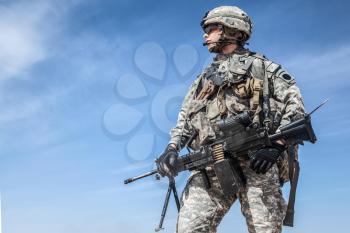 Portrait of United states airborne infantry machinegunner, camo uniforms dress. Combat helmet, goggles, side view
