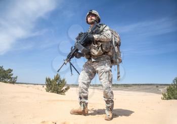 Portrait of United states airborne infantry machinegunner, camo uniforms dress. Combat helmet ammo, front view, full body