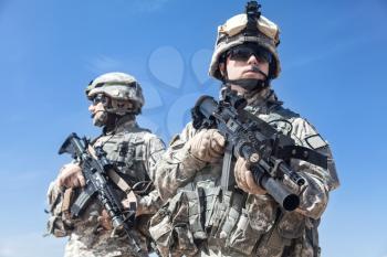 Two United states airborne infantry men with arms, camo uniforms dress. Front view, half length