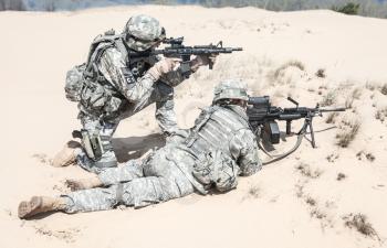 Pair of United states airborne infantry men in action in the desert