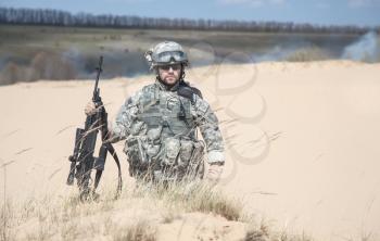 United states airborne infantry man in action in the desert