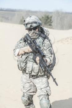 Portrait of United states airborne infantry marksman with arms, camo uniforms dress. Combat helmet on, face mask