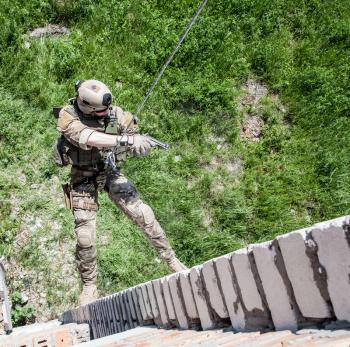 Soldier during assault rappeling exercises with weapons