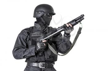 Spec ops police officer SWAT in black uniform with shotgun studio shot