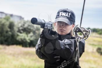 Female police officer SWAT during assault operation