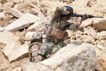 Members of Navy SEAL Team with weapons in action