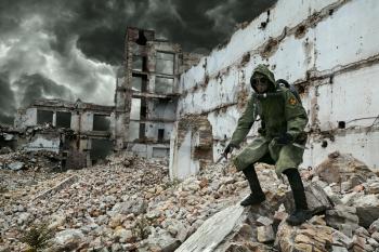 Post apocalypse. Sole survivor in tatters and gas mask on the ruins of the destroyed city 
