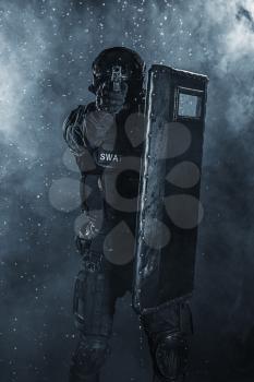 Spec ops police officer SWAT with ballistic shield