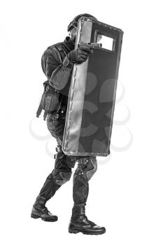 Studio shot of swat police special forces aiming criminals with pistol moving treading hiding behind ballistic shield. Isolated on white full body portrait