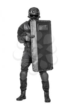 Studio shot of swat police special forces aiming criminals with pistol standing hiding behind ballistic shield. Isolated on white full body portrait