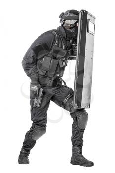 Studio shot of swat police special forces with pistol hiding behind ballistic shield moving treading. Isolated on white full body portrait