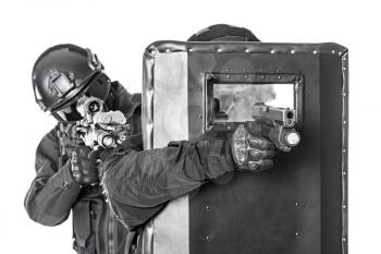 Studio shot of swat police special forces aiming criminals with rifle pistol hiding behind ballistic shield. Isolated on white