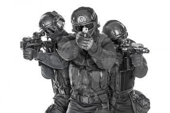 Studio shot of swat police special forces black uniforms pointing terrorists pistol automatic rifle. Tactical helmet vest goggles. Isolated on white