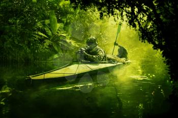 Two special forces operators paddling in the military kayak in the jungle without drawing attention. Diversionary operation ahead