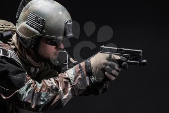 United states Marine Corps special operations command Marsoc raider with pistol. Studio shot of Marine Special Operator black background
