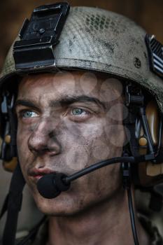 Smoked face of US Army Ranger wearing combat helmet. Closeup portrait. Bright eyes of soldier, young boy at war, sacrifice concept