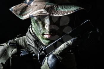 Jagdkommando soldier Austrian special forces with pistol on dark background 