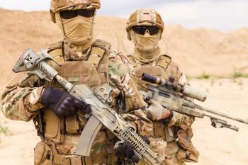 Close-up portrait of equipped and armed special forces soldiers with sniper rifles