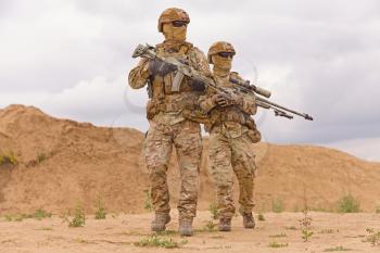 Equipped and armed special forces soldiers in the desert. Concept of military operations.