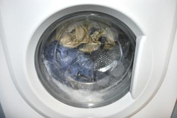 Close-up on a washing machine with clean clothes