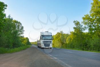 The gray truck on the road in movement