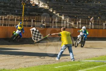 Lviv, Ukraine - 17 April 2016:  Man with a checkered flag indicates the finish at the  Flat Track  National Championship  to the Lviv city