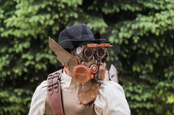 Lviv, Ukraine - May 23.2015:Cosplayer boy and girls posing in a steampunk suit and a respirator mask , Photo taken at cosplayers meeting indoor concert hall in Lviv city.May 23.2015