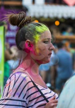Lviv, Ukraine - August 30, 2015: Girl  watching festival of colors in a city park in Lviv.