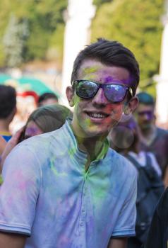 Lviv, Ukraine - August 30, 2015: Man with glases have fun during the festival of color in a city park in Lviv.