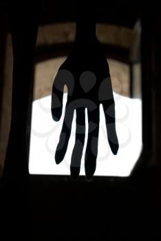 Black hand in front of the window isolated on white