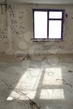 Abandoned empty room with window and light from it
