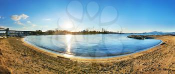 Panoramic view from the sandy beach side. Sunset above the blue bay, city of Vancouver