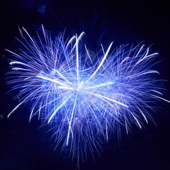 Heart shape of blue colorful fireworks on the black sky background