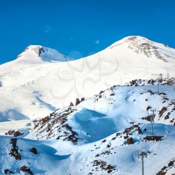 Two peaks of Elbrus mountain in snow. Winter landscape. 