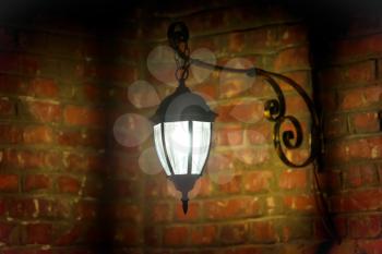 Old lamp on the red brick wall