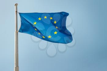 Waving European Union EU flag on the blue sky background