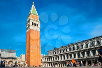 Tourists on San Marco square with Campanile and Doge Palace. Venice, Italy 