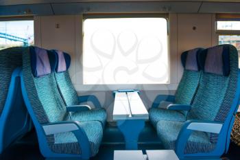 2 class seats in the modern european train with white isolated window