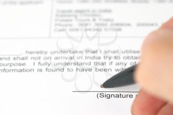 Pen signing contract. Document with place for a signature 