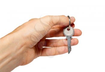 Silver key in a hand isolated on white.