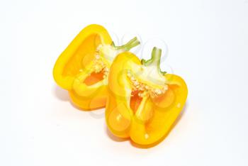 Two halves of slitting yellow paprika isolated on white.