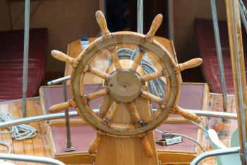 Old wooden steering wheel on the boat 