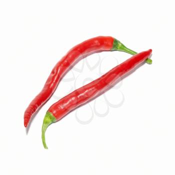 Two red hot chili peppers isolated on white