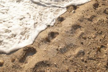Footprints on the golden sandy tropical beach