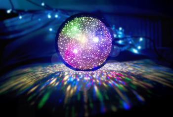 Bright ball of multicolored led lights in darkness. Colourful Glowing Lights.Luminous globe. Holiday background glittering sphere of light.