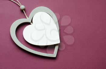 Card with heart shaped pendant for banner design. Card with pendant on red backdrop. . Valentine heart card design